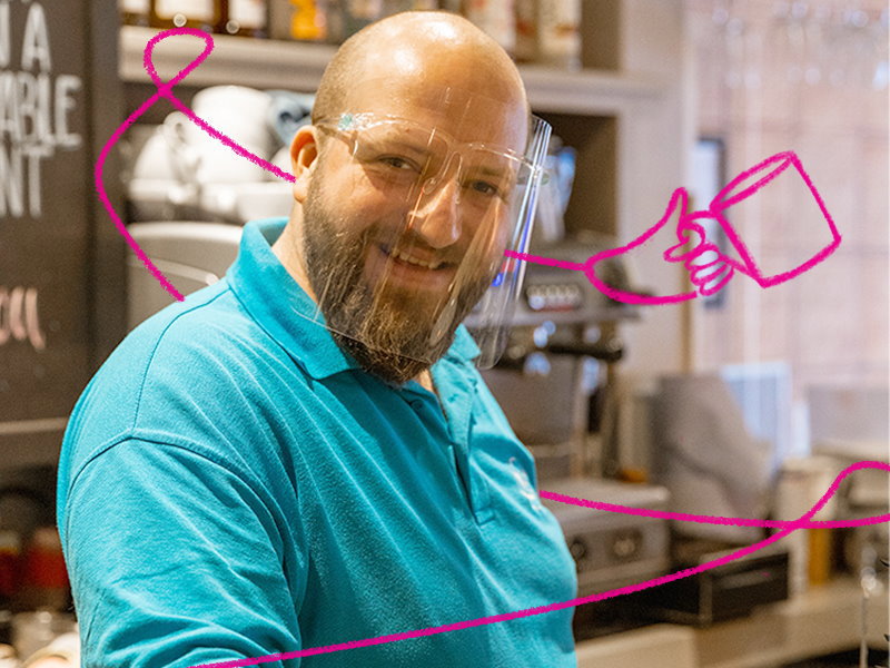 A man making a coffee in a cafe