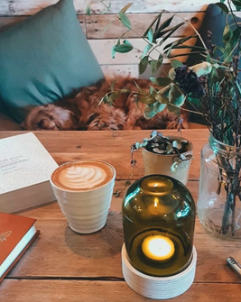 A table inside Oats and Honey with a coffee and some books