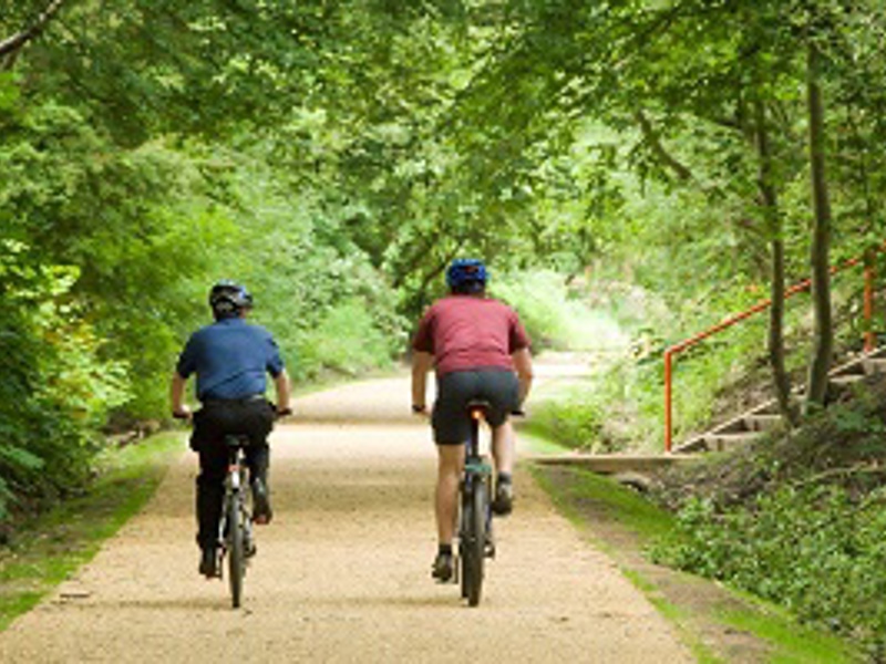 Two cyclists cycling along Bridgewater Greenway